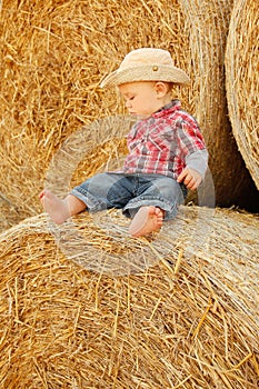 little boy playing in a cowboy hat