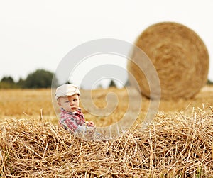 Little boy playing in a cowboy hat on the nature