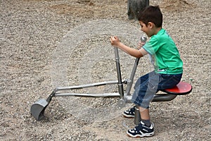 Little boy playing on a digger