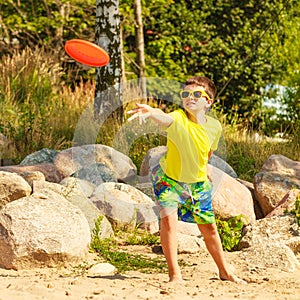 Little boy playing with frisbee disc. photo