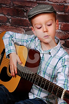 Little boy playing guitar