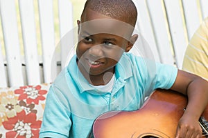 Little boy playing the guitar.