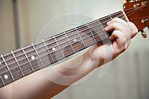 Little boy is playing the guitar