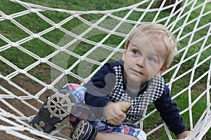 Little boy playing in the hammock