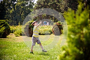 Little boy playing with his soap bubbles toy in the park. Child activity. Springtime concept