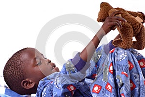 Little boy playing with his teddy bear