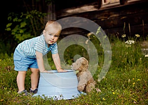 Little boy playing with his teddy bear outdoors