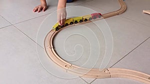 Little boy playing with his wooden trains