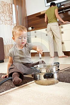 Little boy playing in kitchen