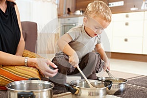 Little boy playing in kitchen