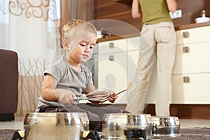 Little boy playing in kitchen