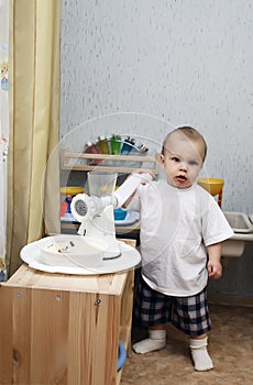 Little boy playing kitchen