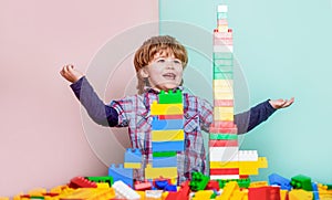 Little boy playing with lots of colorful plastic blocks constructor. Boy playing with construction blocks at