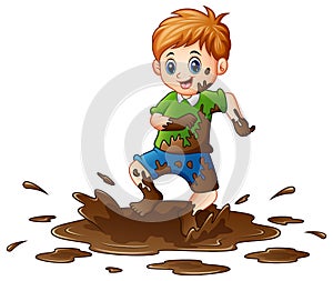 Little boy playing in the mud