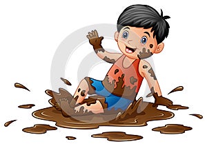 Little boy playing in the mud