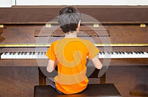 Little boy playing piano learning