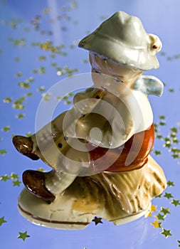 Little boy playing pipe statuette