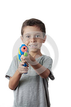 Little boy playing with plastic water gun