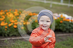 Little boy playing on the playground in the autumn park