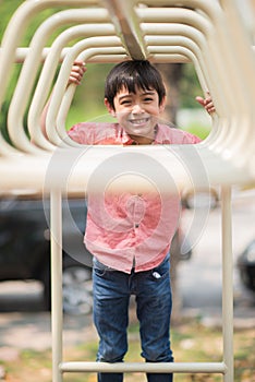 Little boy playing at playground climbing