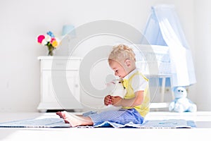 Little boy playing with rabbit pet