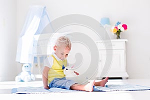 Little boy playing with rabbit pet