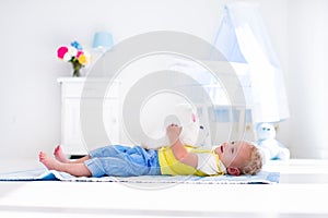 Little boy playing with rabbit pet