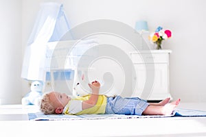 Little boy playing with rabbit pet