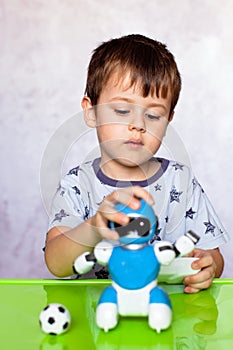 Little boy is playing with robot. Robot for children. Smart toy