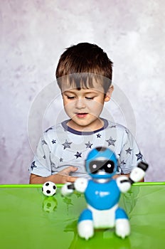 Little boy is playing with robot. Robot for children. Smart toy