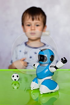 Little boy is playing with robot. Robot for children. Smart toy. Selective focus on toy robot