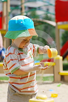 Little boy playing in sandbox