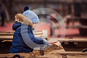Little boy playing in the sandbox