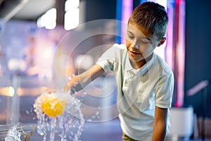 Little boy playing in a science museum