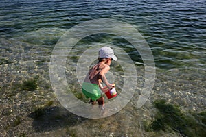 Little boy playing on the sea beach