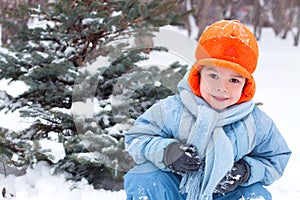 Little boy playing snowballs; photo
