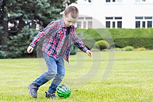 Little  boy  playing soccer with football