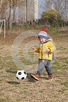 Little boy playing with soccer or football ball. sports for exercise and activity