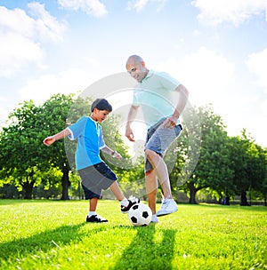 Little Boy Playing Soccer With His Father