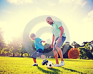 Little Boy Playing Soccer With His Father