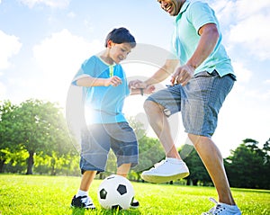 Little Boy Playing Soccer With His Father