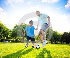 Little Boy Playing Soccer With His Father