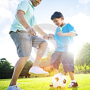 Little Boy Playing Soccer With His Father Concept