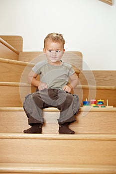 Little boy playing on stairs