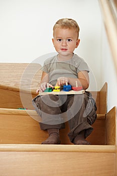 Little boy playing on stairs