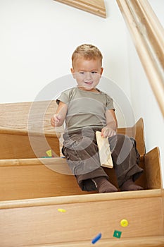 Little boy playing on stairs