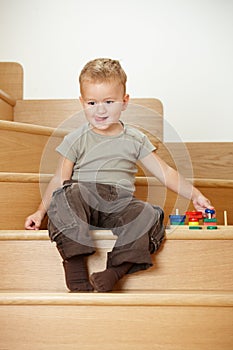 Little boy playing on stairs