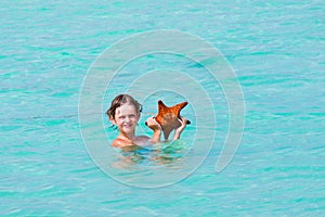 Little boy playing with a star fish