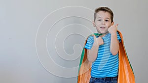 Little boy playing a superhero. Kid in an Superhero`s costume. happy child. green mask, nature care concept