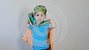 Little boy playing a superhero. Kid in an Superhero`s costume. happy child. green mask, nature care concept